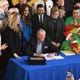 Gov. Phil Murphy looks toward the crowd as he signs legislation allowing undocumented immigrants to obtain a state driver's license at the Snyder Academy in Elizabeth on 12/18/19.