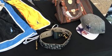 Customs officials display counterfeit goods seized from cargo
