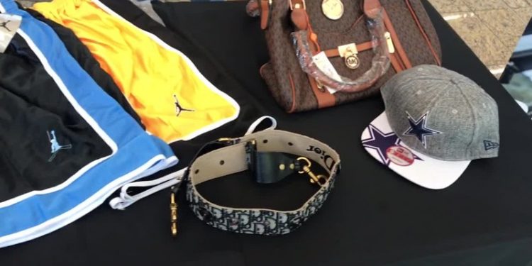Customs officials display counterfeit goods seized from cargo