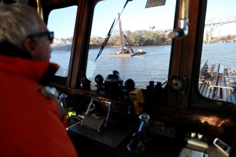 Capt. Jesse Briggs, who works for River Services, guides a tugboat on the Schuylkill.