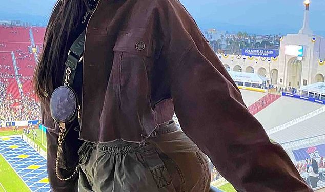 Jordyn Woods channels Kim Possible in green cargo pants as she cheers on the LA Rams with friends