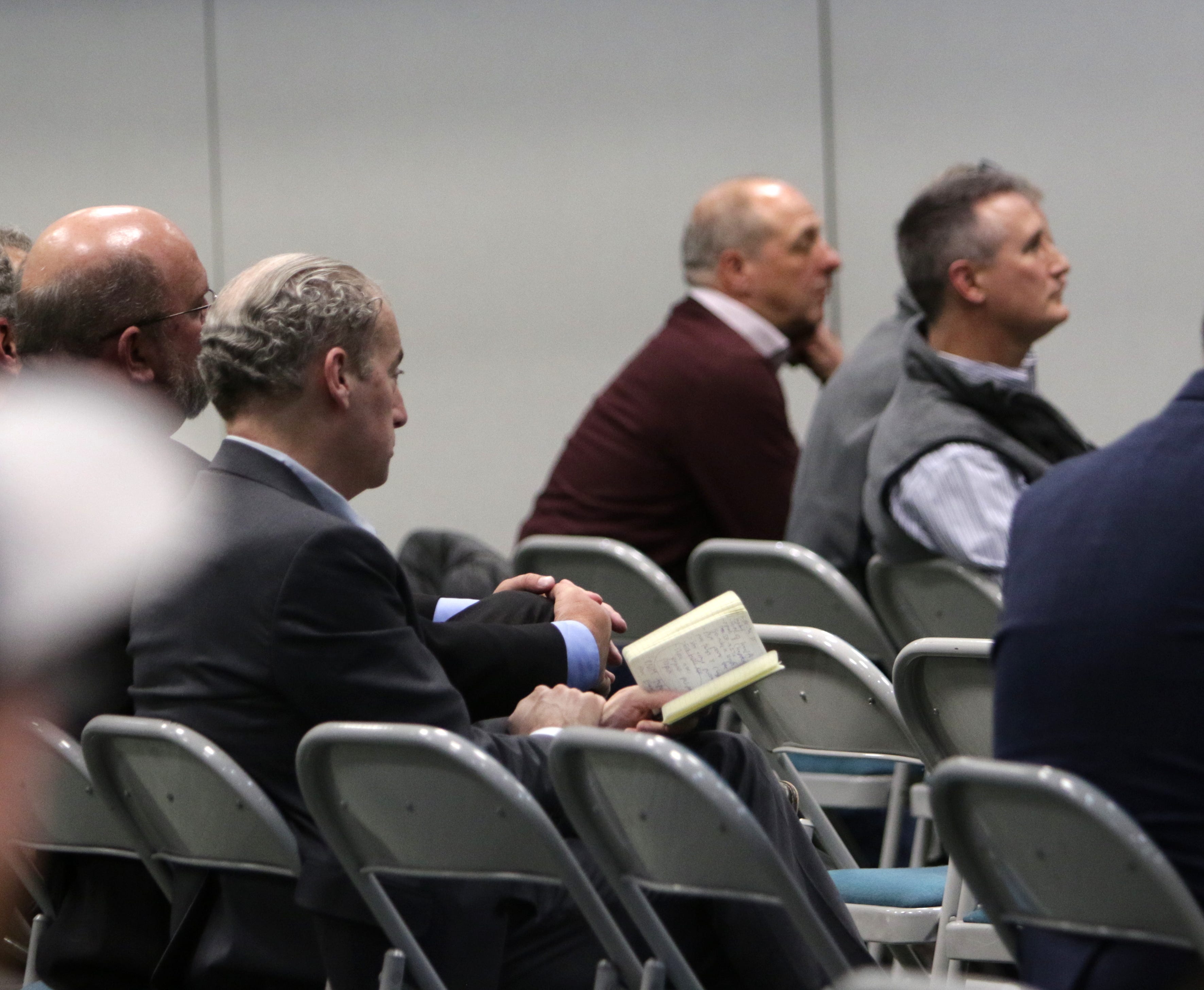 Enchant Energy COO Peter Mandelstam sits next to Farmington Electric Utility System Director Hank Adair, Monday, Jan. 6, 2020, during a public hearing at San Juan College.