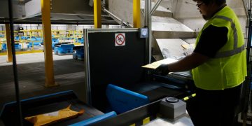 Workers adapt to robots in warehouse