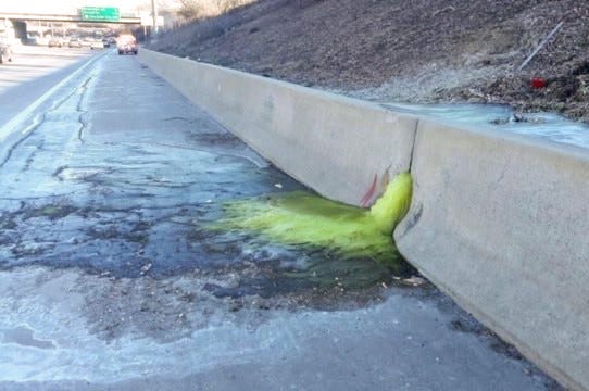 A greenish-yellow liquid flows through a retaining wall on I-696, triggering a lane closure Friday afternoon and haz-mat clean-up Friday night, Dec. 20, 2019.