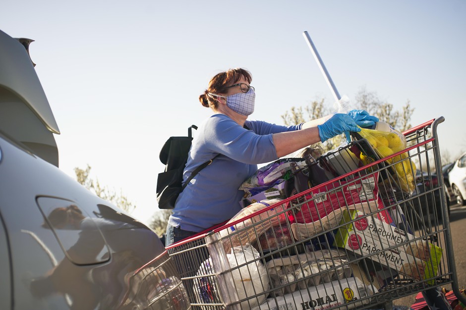 A Costco customer loads groceries into her car in Tigard, Oregon, March 20, 2020.