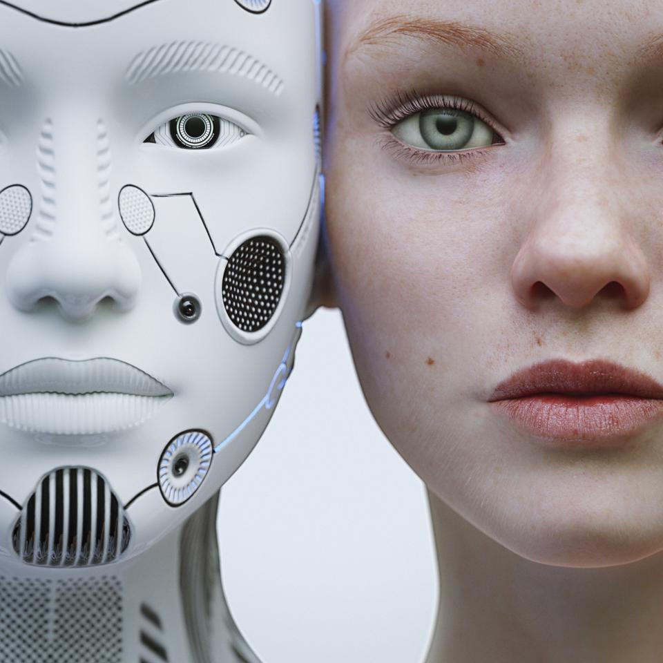 Female robot and human heads side by side