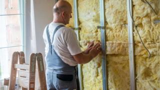 A builder fitting wool insulation