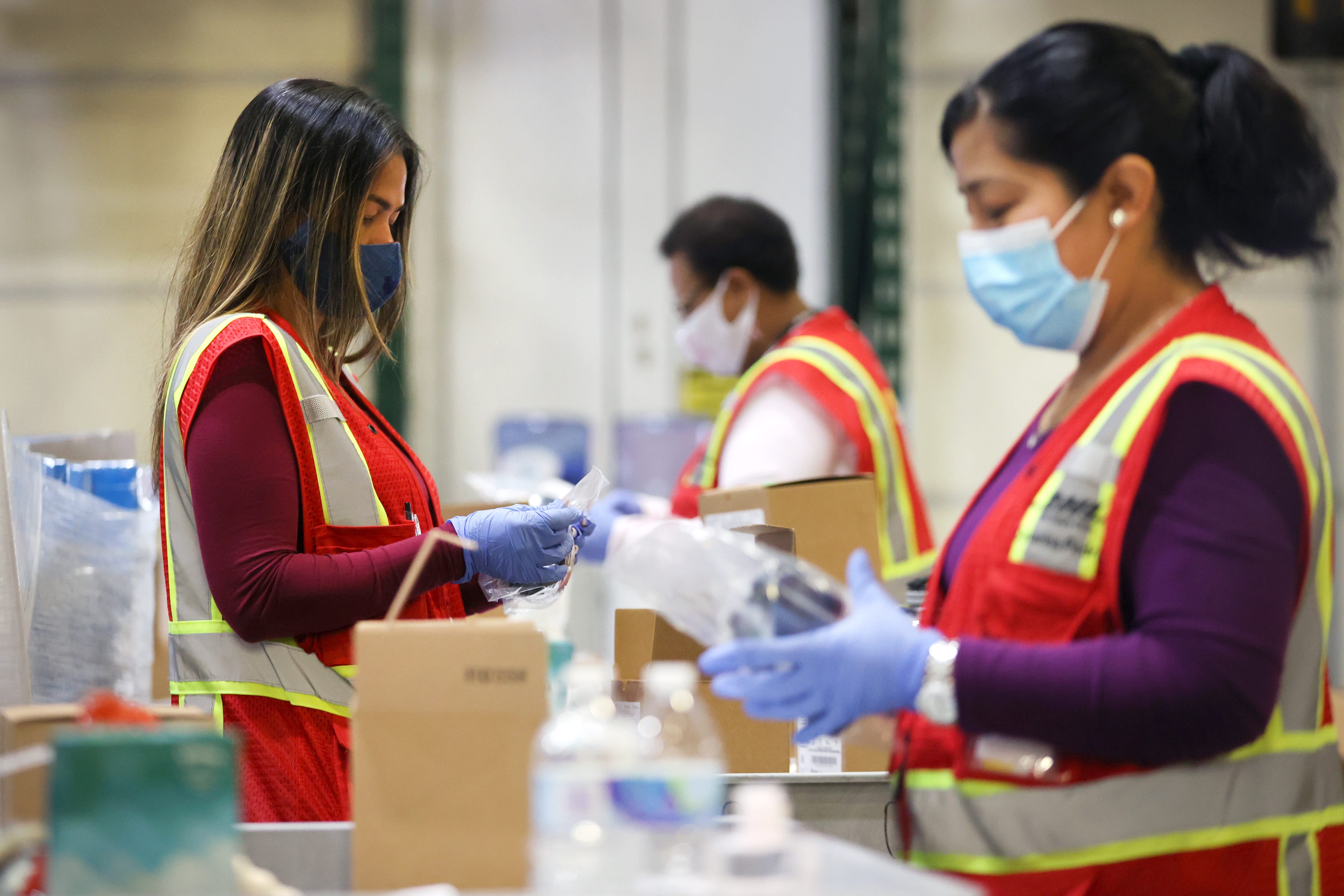 Quality control workers sort through and inspect some of the shipments from the DHL Supply Chain facility in Southaven Monday, Oct. 5, 2020. 