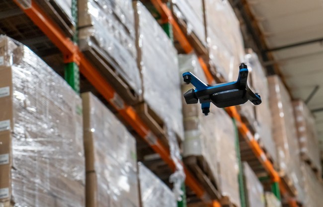 Ware drone flying in a warehouse and collecting inventory data.