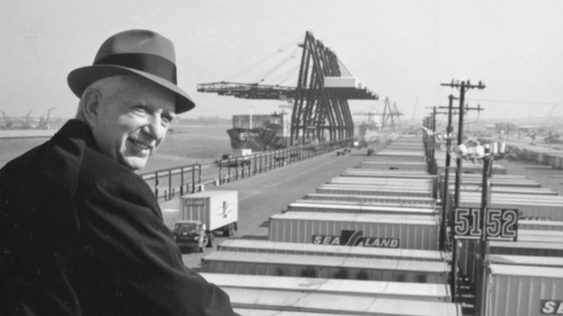Malcom McLean shown dockside above Sea-Land containers.  A.P. Møller - Mærsk purchased Sea-Land in 1999. 
(Photo: americanbusinesshistory.org)