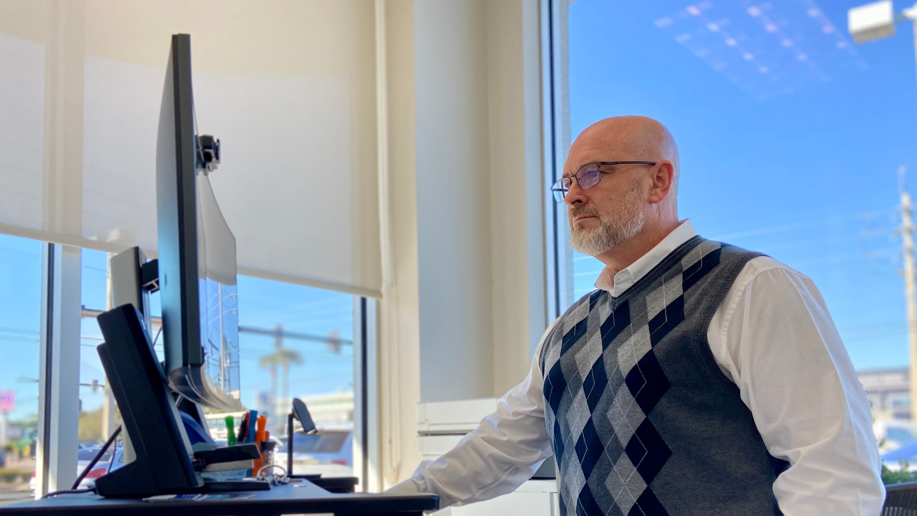 Tom Bush BMW Certified Pre-Owned Sales Manager Andrew Buttrill studies pre-owned vehicles available at the auctions.