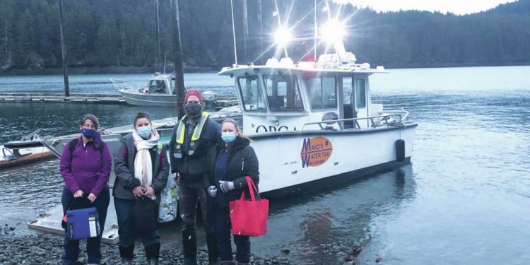 ‘Capt. Balto’ drives boat in rough seas to deliver vaccine, medical workers