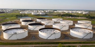 Falling crude inventories boost oil over $50