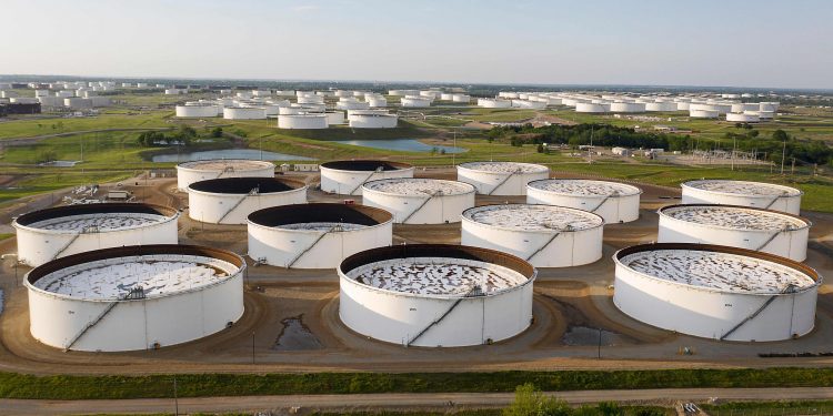 Falling crude inventories boost oil over $50