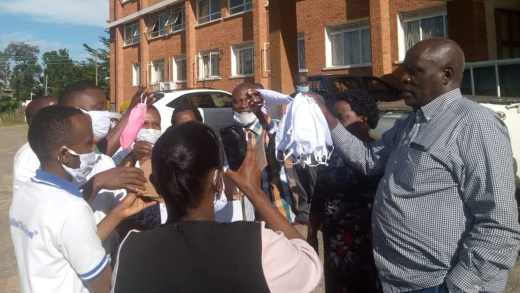 KIU nursing students handing over masks to officials in the Bushenyi district (Photo courtesy of Annet Kabanyoro)