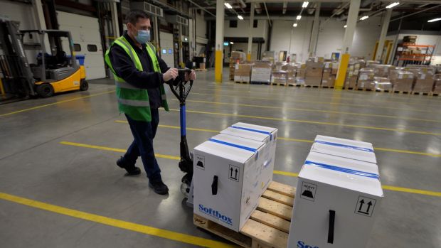 A member of the Cold Chain warehouse operations team moves ‘shipper’ boxes, which contain ‘pizza boxes’ boxes of the Pfizer/BioNTech vaccine vials. Photograph: Alan Betson