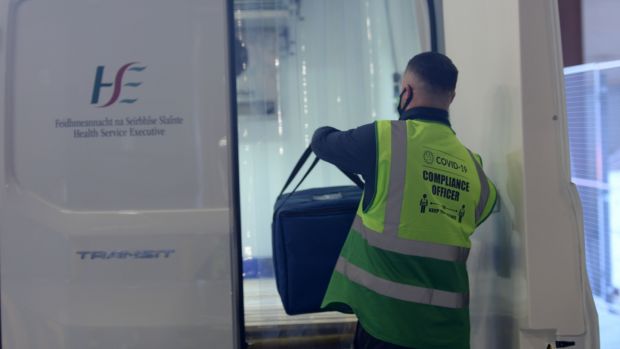 A driver loads Pfizer/BioNTech vaccines into a refrigerated van after collecting them from the National Cold Chain Distribution Centre. Photograph: Alan Betson