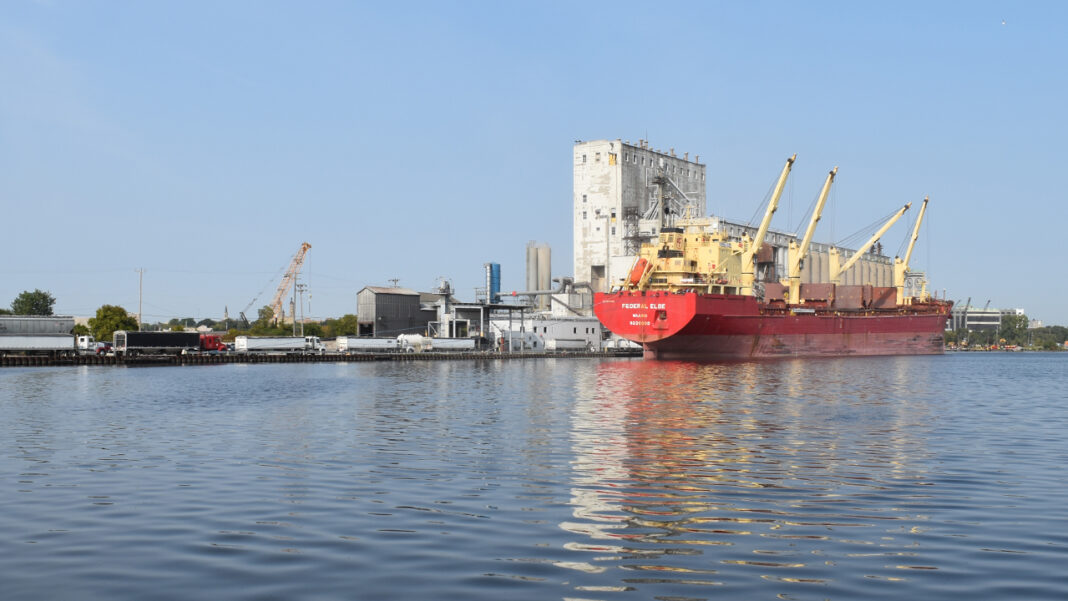 Trucks line up to deliver agricultural products to the privately-operated Cofco International grain elevator in the Milwaukee harbor.