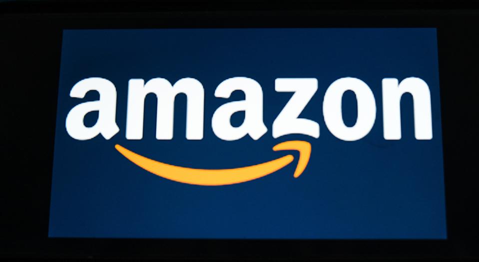 In this photo illustration an Amazon logo seen displayed on...
