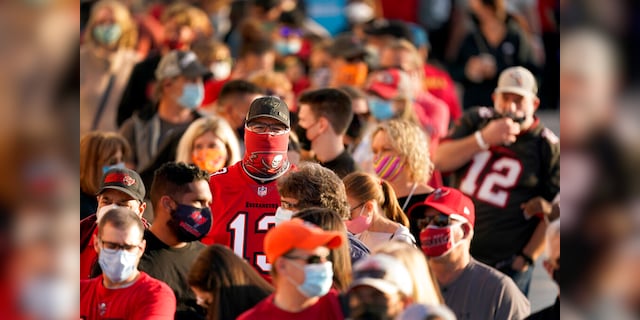In this Feb. 4, 2021, file photo, people wait in line for an exhibit at the NFL Experience in Tampa, Fla. The city is hosting Sunday's Super Bowl football game between the Tampa Bay Buccaneers and the Kansas City Chiefs. (AP Photo/Charlie Riedel, File)