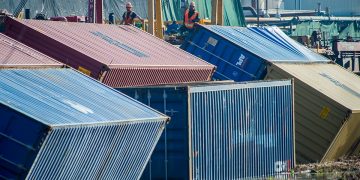 A train derailment caused cargo containers to fall into a canal. – The Augusta Chronicle